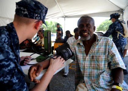 Defense.gov News Photo 110413-N-NY820-033 - U.S. Navy Petty Officer Ryan Wyatt left examines a patient on the first day of a medical screening clinic in Kingston Jamaica during Continuing photo