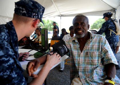 Defense.gov News Photo 110413-N-NY820-033 - U.S. Navy Petty Officer Ryan Wyatt left examines a patient on the first day of a medical screening clinic in Kingston Jamaica during Continuing