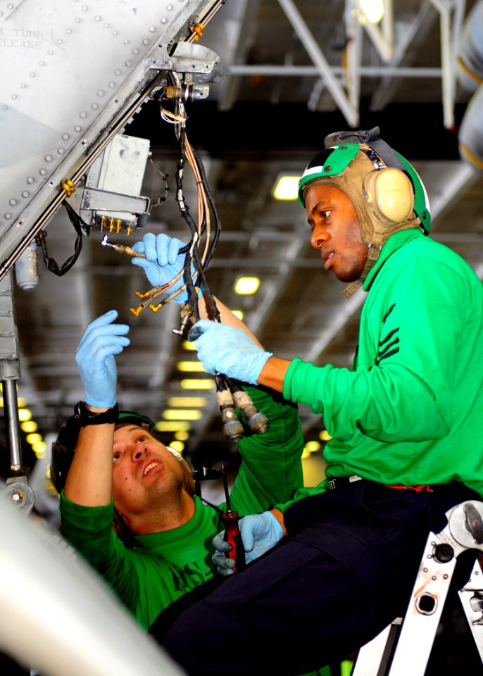 Defense.gov News Photo 110416-N-RG360-021 - Petty Officer 1st Class William Schuyler right and Petty Officer 1st Class Jason Siani both assigned to Anti-Submarine Helicopter Squadron 4