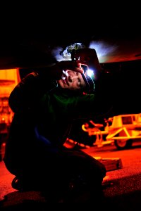 Defense.gov News Photo 110528-N-GC412-042 - Petty Officer 2nd Class Andrew Savini rewires a shut off valve to an external fuel cell on an F A-18C Hornet aboard the aircraft carrier USS John