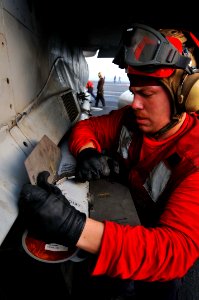 Defense.gov News Photo 110520-N-1004S-032 - Petty Officer Korey Chavis assigned to Strike Fighter Squadron 146 installs wing and fin attachments to an AIM-120 AMRAAM missile aboard the