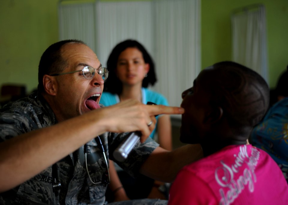Defense.gov News Photo 110603-N-NY820-090 - U.S. Air Force Maj. Gary Ruesch left examines a patient at Escuela Max Seidel in Tumaco Colombia during Continuing Promise 2011. Continuing