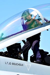 Defense.gov News Photo 110413-N-1004S-222 - Airman Steven Gardner assigned to Strike Fighter Squadron 154 cleans the cockpit window of an F A-18F Super Hornet aboard the aircraft carrier
