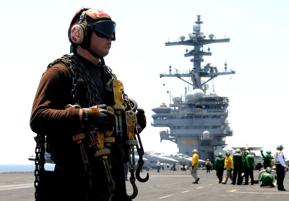 Defense.gov News Photo 110616-N-QL471-184 - Airman Gregory Bradshaw prepares to secure an aircraft with chains aboard the aircraft carrier USS George H.W. Bush CVN 77 underway in the