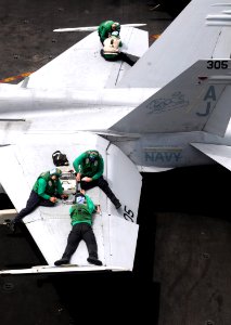 Defense.gov News Photo 110621-N-QL471-078 - Sailors assigned to Strike Fighter Squadron 15 perform maintenance on an F A-18C Hornet aboard the aircraft carrier USS George H.W. Bush CVN 77 in