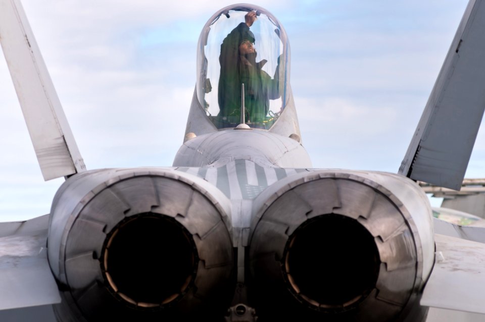 Defense.gov News Photo 110606-N-BT887-006 - U.S. Navy Airman Julian Parrera cleans the canopy of an F A-18C Hornet from Strike Fighter Squadron 192 aboard the aircraft carrier USS John C