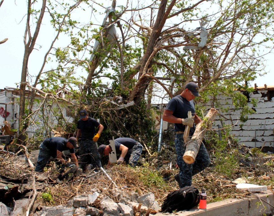 Defense.gov News Photo 110607-N-ZZ999-003 - Petty Officer 2nd Class Pat Patterson left Lt. j.g. Joe Innerst Petty Officer 2nd Class Travis Fitzgerald and Lt. Ryan Sullivan clear debris