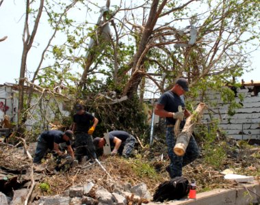 Defense.gov News Photo 110607-N-ZZ999-003 - Petty Officer 2nd Class Pat Patterson left Lt. j.g. Joe Innerst Petty Officer 2nd Class Travis Fitzgerald and Lt. Ryan Sullivan clear debris