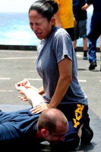 Defense.gov News Photo 110510-N-RC734-189 - Petty Officer 2nd Class Jaqueline Rodriguez subdues a simulated suspect after being sprayed with oleoresin capsicum spray also known as pepper