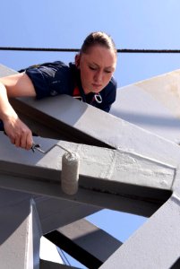 Defense.gov News Photo 110531-N-QP268-068 - U.S. Navy Seaman Kasey Karnau paints the top of the double-arm pivoting gravity davit aboard the amphibious dock landing ship USS Whidbey Island