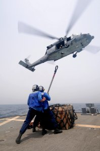 Defense.gov News Photo 110715-N-XQ375-398 - Seaman Matt Binnie left and Seaman Lucio Robles prepare to attach a cargo net to an MH-60S Sea Hawk helicopter during a vertical replenishment