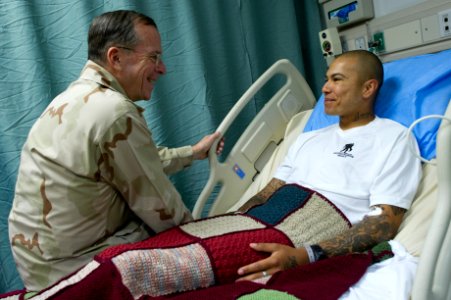 Defense.gov News Photo 110801-N-TT977-198 - Chairman of the Joint Chiefs of Staff Adm. Mike Mullen visits with U.S. Army Spc. Rosasgarza Francisco a patient at Craig Joint Theater Hospital