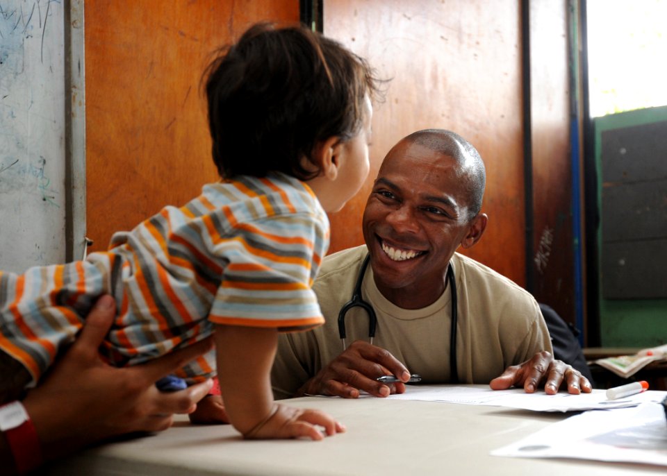 Defense.gov News Photo 110717-N-NY820-150 - U.S. Air Force Capt. Chuck Henderson right interacts with a patient at the Instituto Nacional de Acajutla medical site in Acajutla El Salvador