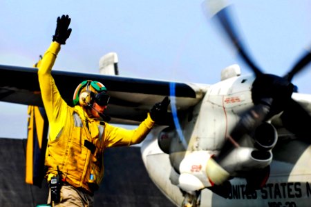 Defense.gov News Photo 110630-N-GL340-109 - U.S. Navy Lt. Jerrod Washburn signals the launch of a C-2A Greyhound from the aircraft carrier USS Ronald Reagan CVN 76 in the Arabian Sea on June
