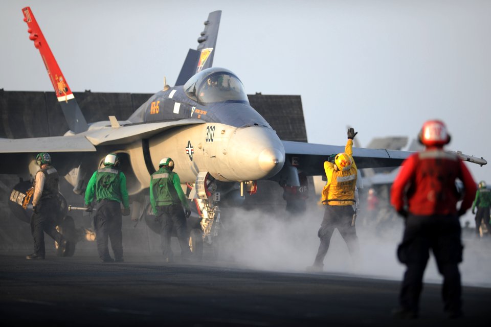 Defense.gov News Photo 110802-N-YZ751-405 - U.S. Navy sailors prepare to launch an F A-18C Hornet aircraft assigned to Strike Fighter Squadron 15 aboard the aircraft carrier USS George H.W