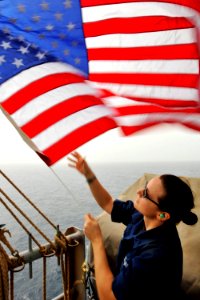 Defense.gov News Photo 110704-N-EE987-066 - Seaman Ingrid Devinkayne sets Fourth of July colors on the weather deck of the aircraft carrier USS Ronald Reagan CVN 76 in the Arabian Sea on July
