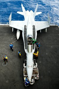 Defense.gov News Photo 110809-N-BT887-147 - U.S. Navy sailors prepare to maneuver an F A-18C Hornet aircraft assigned to Strike Fighter Squadron 97 on the aircraft carrier USS John C