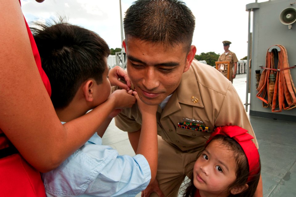 Defense.gov News Photo 110916-N-CZ945-173 - U.S. Navy Chief Petty Officer Kim Mercado has his chief petty officer anchors pinned on his collar by his son and daughter at the U.S. 7th Fleet