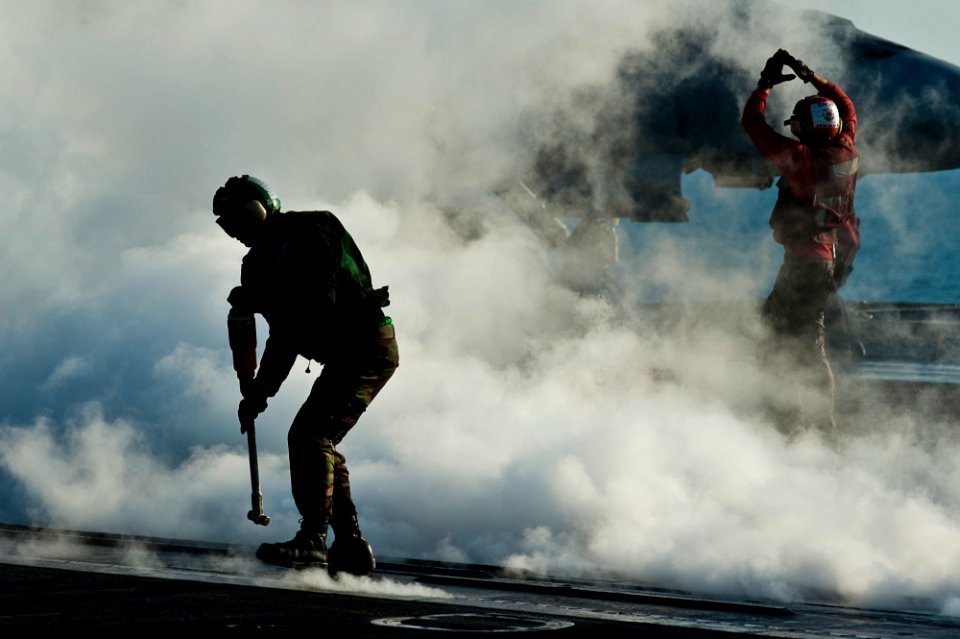 Defense.gov News Photo 111128-N-BT887-106 - A U.S. Navy sailor retrieves a hold back bar during flight operations aboard the aircraft carrier USS John C. Stennis CVN 74 in the Arabian Gulf on