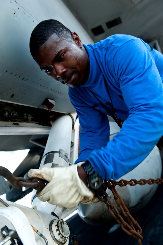 Defense.gov News Photo 110816-N-BT887-011 - Airman Cameron Brown attaches a chain to an F A-18F Super Hornet assigned to Strike Fighter Squadron 41 aboard the aircraft carrier USS John C