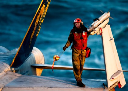 Defense.gov News Photo 111203-N-BT887-175 - A U.S. Navy sailor removes the cap from an AIM-9 missile attached to an F A-18C Hornet aircraft aboard the aircraft carrier USS John C. Stennis CVN