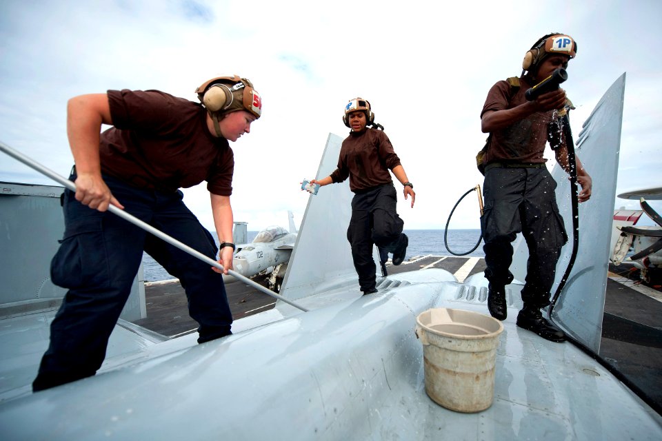 Defense.gov News Photo 111206-N-DR144-601 - U.S. Navy Seaman Katie Griffith Petty Officer 3rd Class Veronica Calhoun and Seaman Reginald Dean wash down an F A-18F Super Hornet on the flight