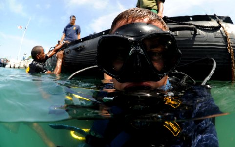 Defense.gov News Photo 110722-N-XD935-246 - U.S. Navy Petty Officer 2nd Class Justin McMillen assigned to Mobile Diving and Salvage Unit 2 surfaces after a dive with a member of the photo