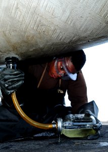 Defense.gov News Photo 110801-N-SG869-036 - Airman Raven King takes fuel samples from an F A-18 Hornet aboard the aircraft carrier USS Ronald Reagan CVN 76 in the Arabian Sea on Aug. 1 2011