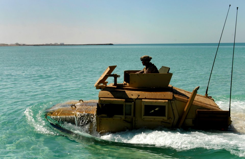 Defense.gov News Photo 111114-N-KA046-188 - A Marine from the 22nd Marine Expeditionary Unit drives a Humvee to shore after launching from a landing craft utility assigned to the amphibious