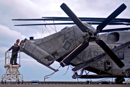 Defense.gov News Photo 111220-N-DX615-041 - U.S. Marines perform maintenance on a CH-53E Super Stallion aboard the USS Makin Island LHD 8 underway in the Pacific Ocean on Dec. 20 2011. The photo