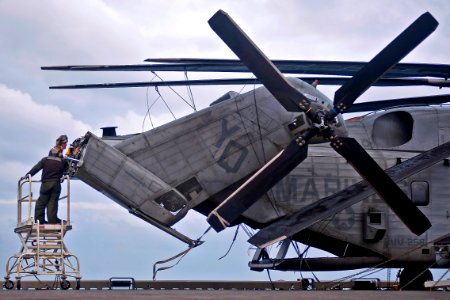 Defense.gov News Photo 111220-N-DX615-041 - U.S. Marines perform maintenance on a CH-53E Super Stallion aboard the USS Makin Island LHD 8 underway in the Pacific Ocean on Dec. 20 2011. The