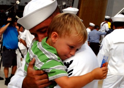 Defense.gov News Photo 110805-N-YF783-182 - Petty Officer 2nd Class Tommy Neely holds his son after returning home from a seven-month independent deployment aboard the guided-missile photo