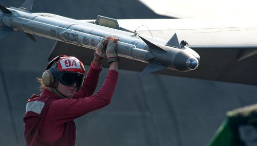Defense.gov News Photo 111210-N-OY799-345 - Airman Tiffany Wilchek arms ordnance on an F A-18C Hornet assigned to Strike Fighter Squadron 97 on the flight deck of the aircraft carrier USS
