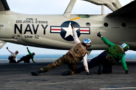 Defense.gov News Photo 110917-N-BT887-389 - Flight deck crew members give the thumbs up to launch an E-2C Hawkeye from the USS John C. Stennis CVN 74 as the aircraft carrier conducts flight