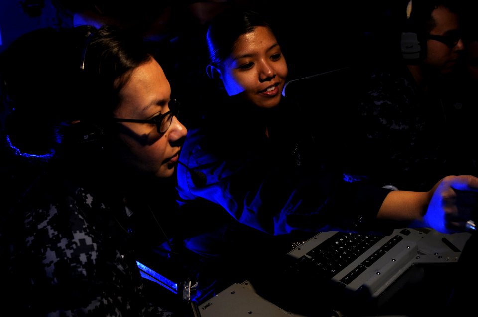 Defense.gov News Photo 120120-N-RG587-102 - U.S. Navy Petty Officer 2nd Class Katherine Newquist left and Seaman Apprentice Leizle Aspili analyze radar frequencies in the electronic warfare