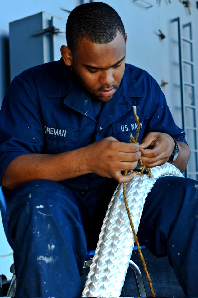 Defense.gov News Photo 120128-N-JE709-051 - U.S. Navy Seaman Jonathon Foreman splices a tattletale through a new mooring line aboard aircraft carrier USS George H.W. Bush CVN 77 in the
