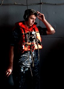 Defense.gov News Photo 111229-N-BT887-048 - Seaman Seth Coulter dons protective gear before a replenishment at sea aboard the aircraft carrier USS John C. Stennis CVN 74 in the Arabian Sea on