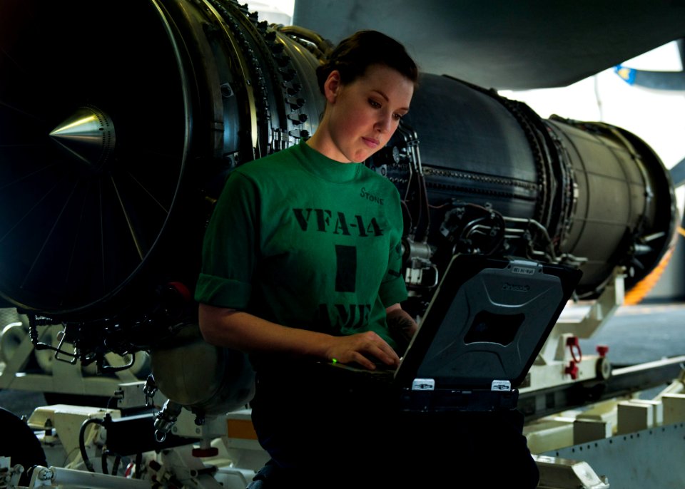 Defense.gov News Photo 120106-N-BT887-332 - Petty Officer 3rd Class Sarah Stone reads the instructions for installing a fire bottle into an F A-18E Super Hornet from Strike Fighter Squadron