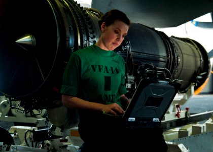 Defense.gov News Photo 120106-N-BT887-332 - Petty Officer 3rd Class Sarah Stone reads the instructions for installing a fire bottle into an F A-18E Super Hornet from Strike Fighter Squadron