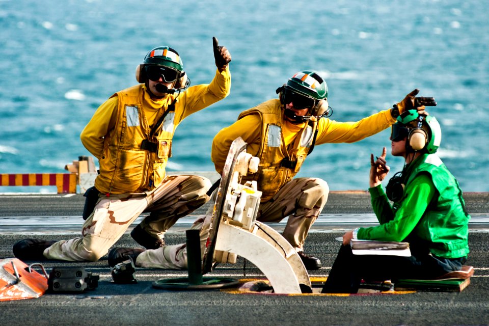 Defense.gov News Photo 111120-N-BT887-071 - U.S. Navy sailors signal the launch of an F A-18F Super Hornet assigned to Strike Fighter Squadron 41 aboard the aircraft carrier USS John C