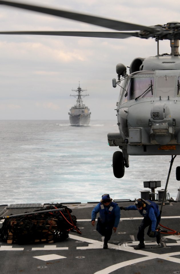 Defense.gov News Photo 111129-N-XQ375-322 - Seaman Lucio Robles left and Seaman Daniel Nogal clear the flight deck of the guided-missile destroyer USS Mitscher DDG 57 after attaching a cargo