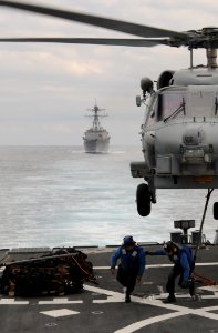 Defense.gov News Photo 111129-N-XQ375-322 - Seaman Lucio Robles left and Seaman Daniel Nogal clear the flight deck of the guided-missile destroyer USS Mitscher DDG 57 after attaching a cargo