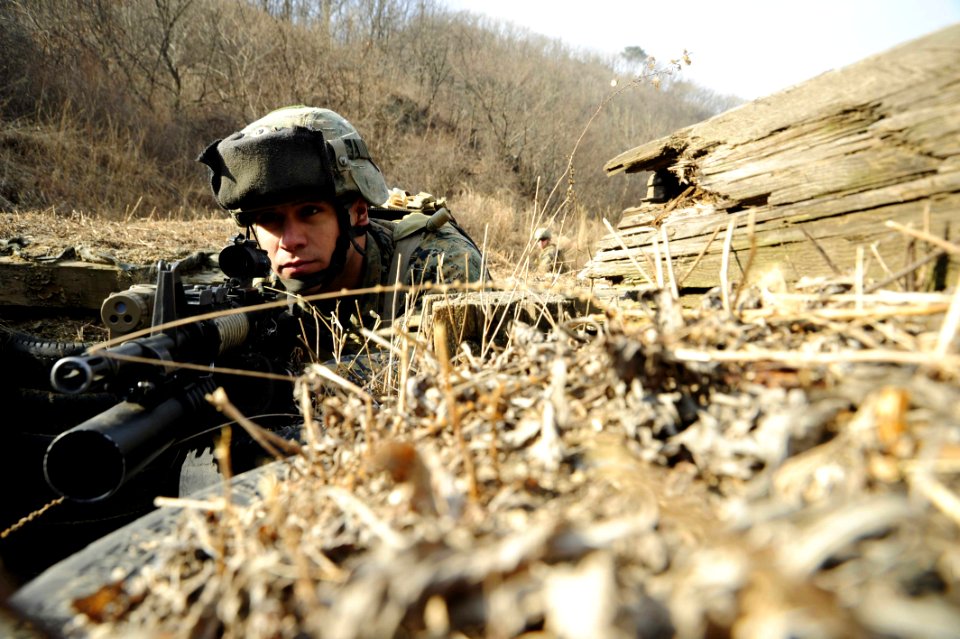 Defense.gov News Photo 120301-N-SD300-072 - U.S. Marine Corps Lance Cpl. Mario Melendez assigned to Fleet Antiterrorism Security Team Pacific stands guard as fellow Marines clear a trench