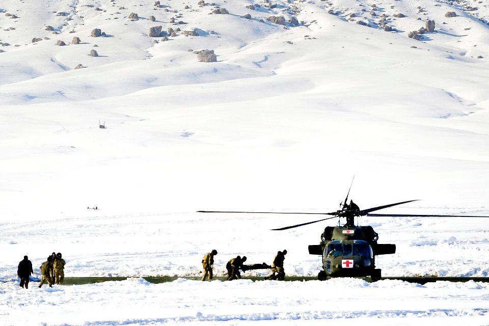 Defense.gov News Photo 120127-N-CI175-134 - Afghan police and coalition special operations forces load a police member needing medical care onto an MH-60 Black Hawk helicopter during a