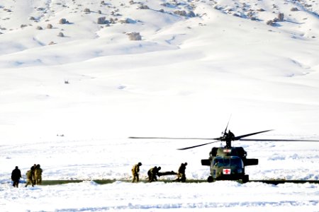 Defense.gov News Photo 120127-N-CI175-134 - Afghan police and coalition special operations forces load a police member needing medical care onto an MH-60 Black Hawk helicopter during a