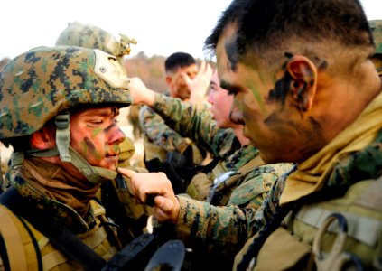 Defense.gov News Photo 120303-N-SD300-026 - Cpl. Mario Melendez right assigned to 2nd Platoon Company Pacific Fleet Anti-Terrorism Security Team applies camouflage paint to Lance Cpl