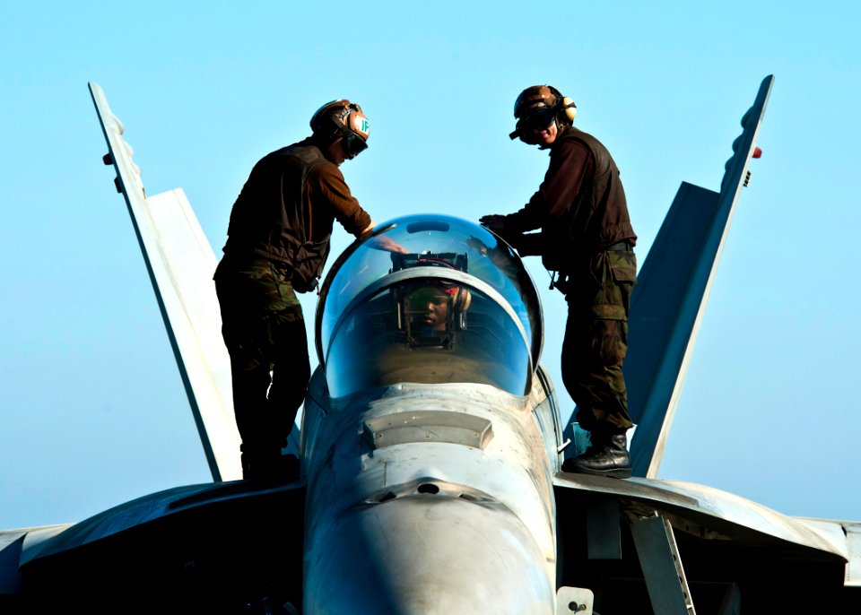 Defense.gov News Photo 111214-N-BT887-391 - U.S. Navy sailors wipe down the canopy of an F A-18F Super Hornet aircraft attached to Strike Fighter Squadron 41 aboard the aircraft carrier USS