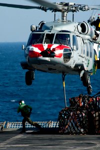 Defense.gov News Photo 111221-N-OY799-360 - An MH-60S Sea Hawk helicopter from Sea Combat Squadron 8 picks up stores from the flight deck of the Military Sealift Command fast combat support