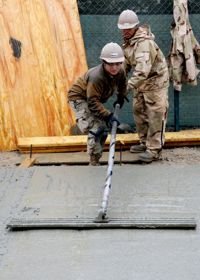 Defense.gov News Photo 120217-N-SD610-012 - Petty Officer Selina Rodriguez assigned to Naval Mobile Construction Battalion 7 uses a bull float to finish concrete at Kandahar Airfield on