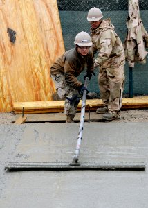 Defense.gov News Photo 120217-N-SD610-012 - Petty Officer Selina Rodriguez assigned to Naval Mobile Construction Battalion 7 uses a bull float to finish concrete at Kandahar Airfield on